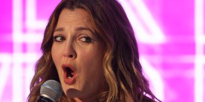 Drew Barrymore speaking into a microphone