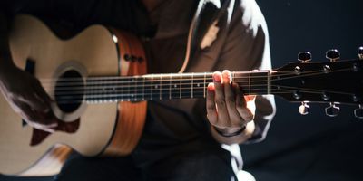 man playing acoustic guitar