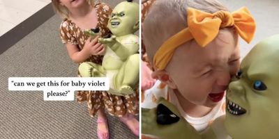 little girl holding a green demon baby