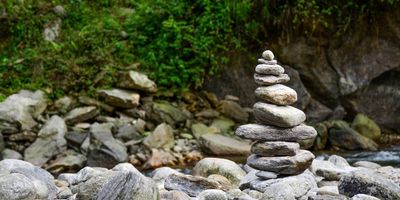 Rocks stacked in a cairn by the water