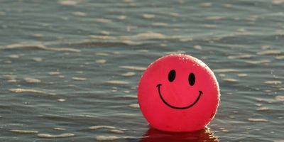 smiley face ball floating in the water