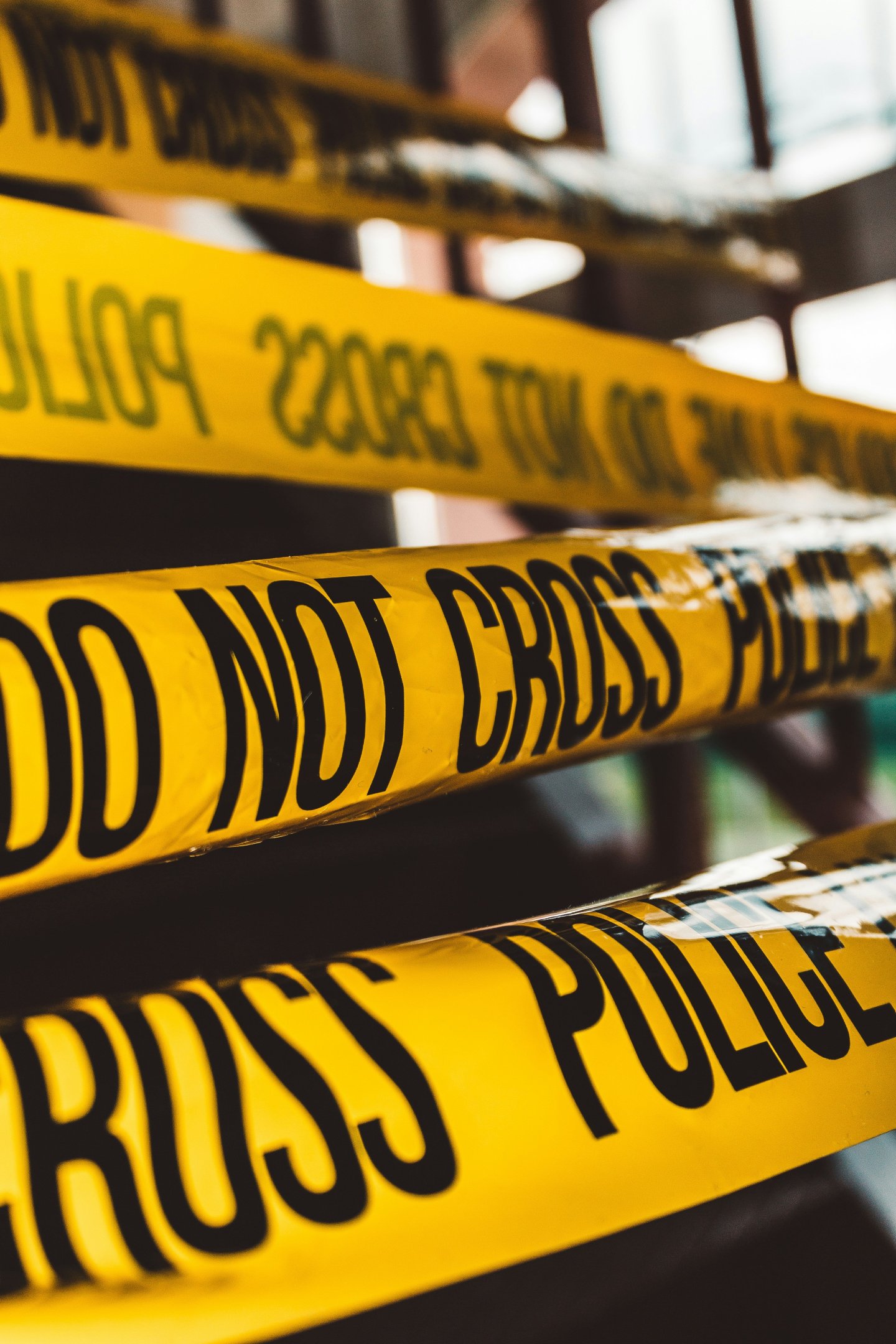 Yellow "Do Not Cross" police tape in a close-up view.