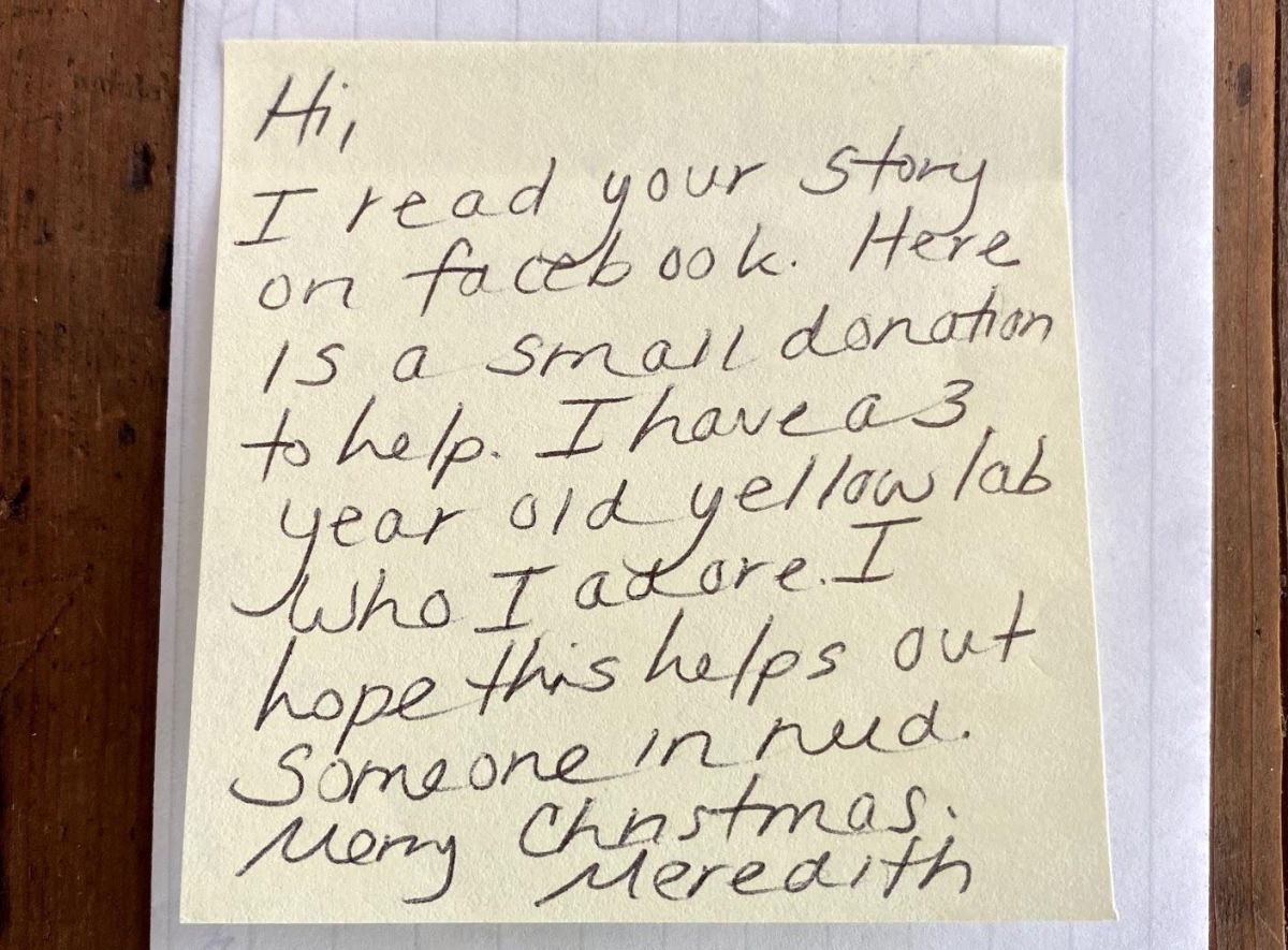 Yellow post-it note with handwritten note that reads: