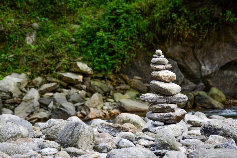 Rocks stacked in a cairn by the water