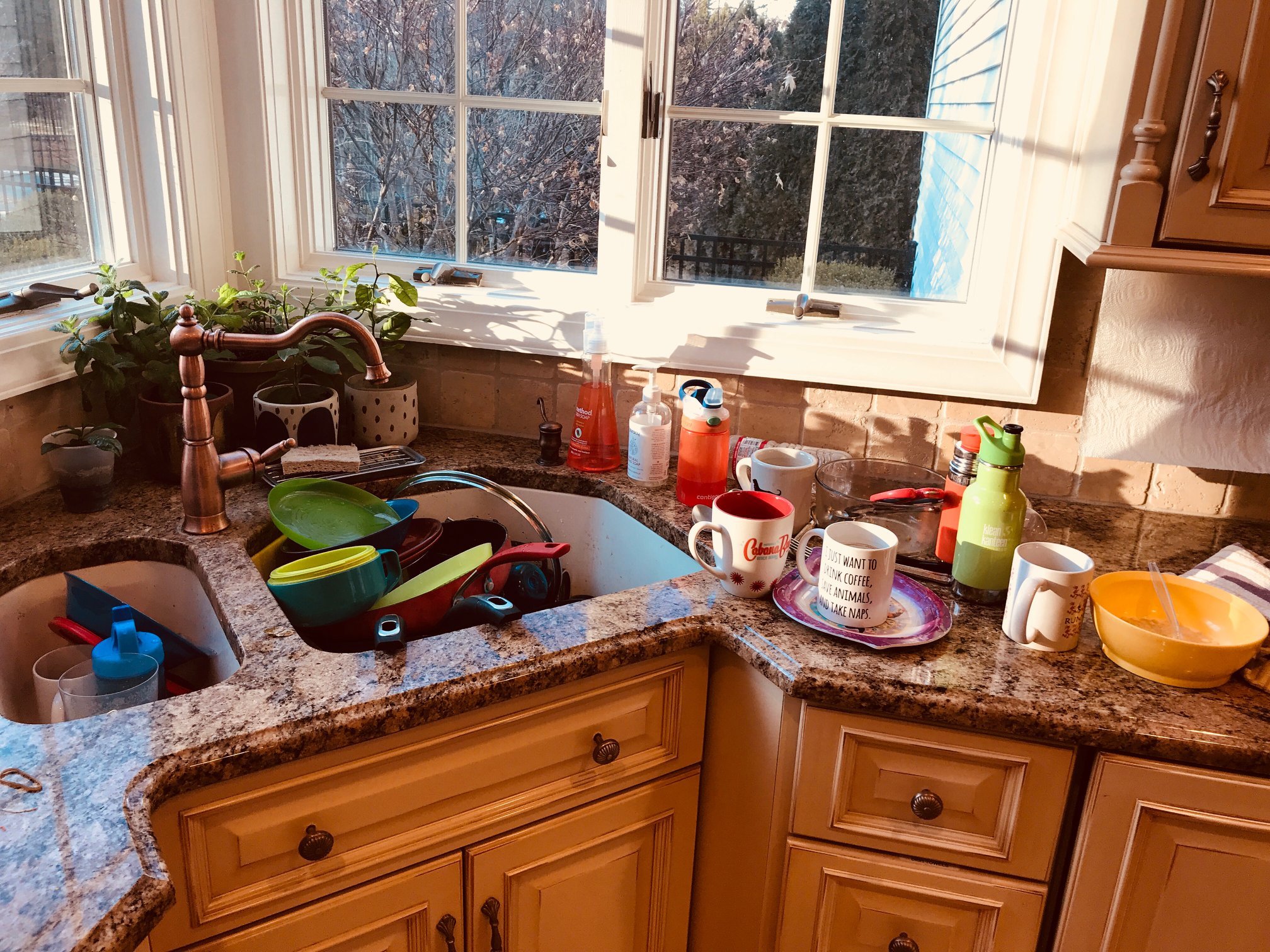 a kitchen sink full of dirty dishes