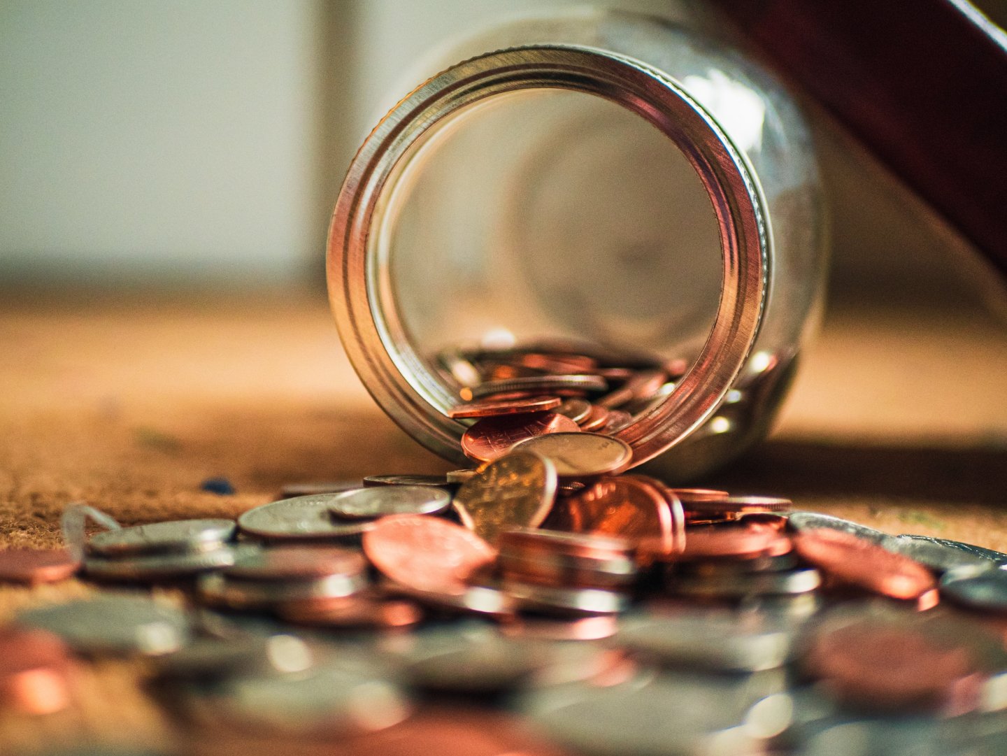 a jar of coins spilled onto the floor