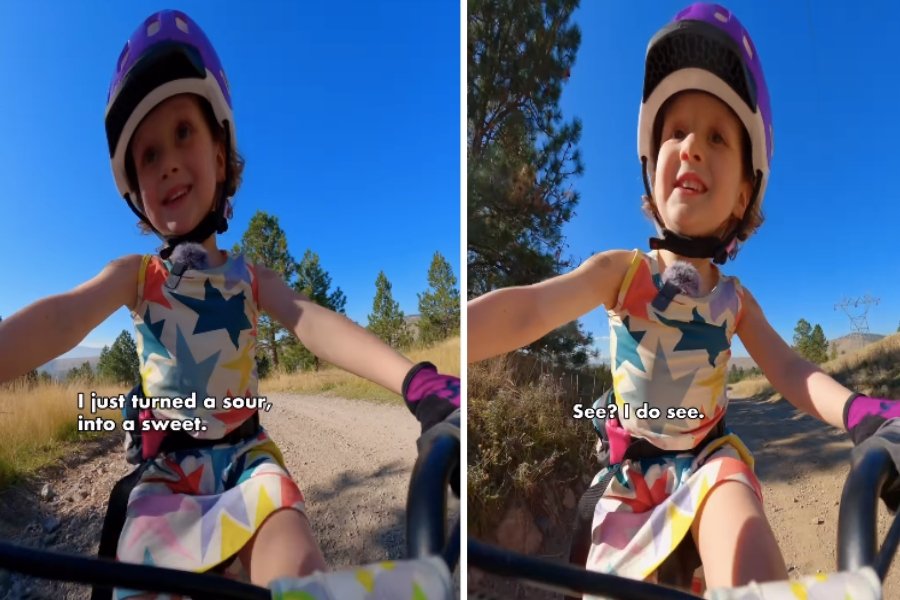 a little girl riding a bike and smiling