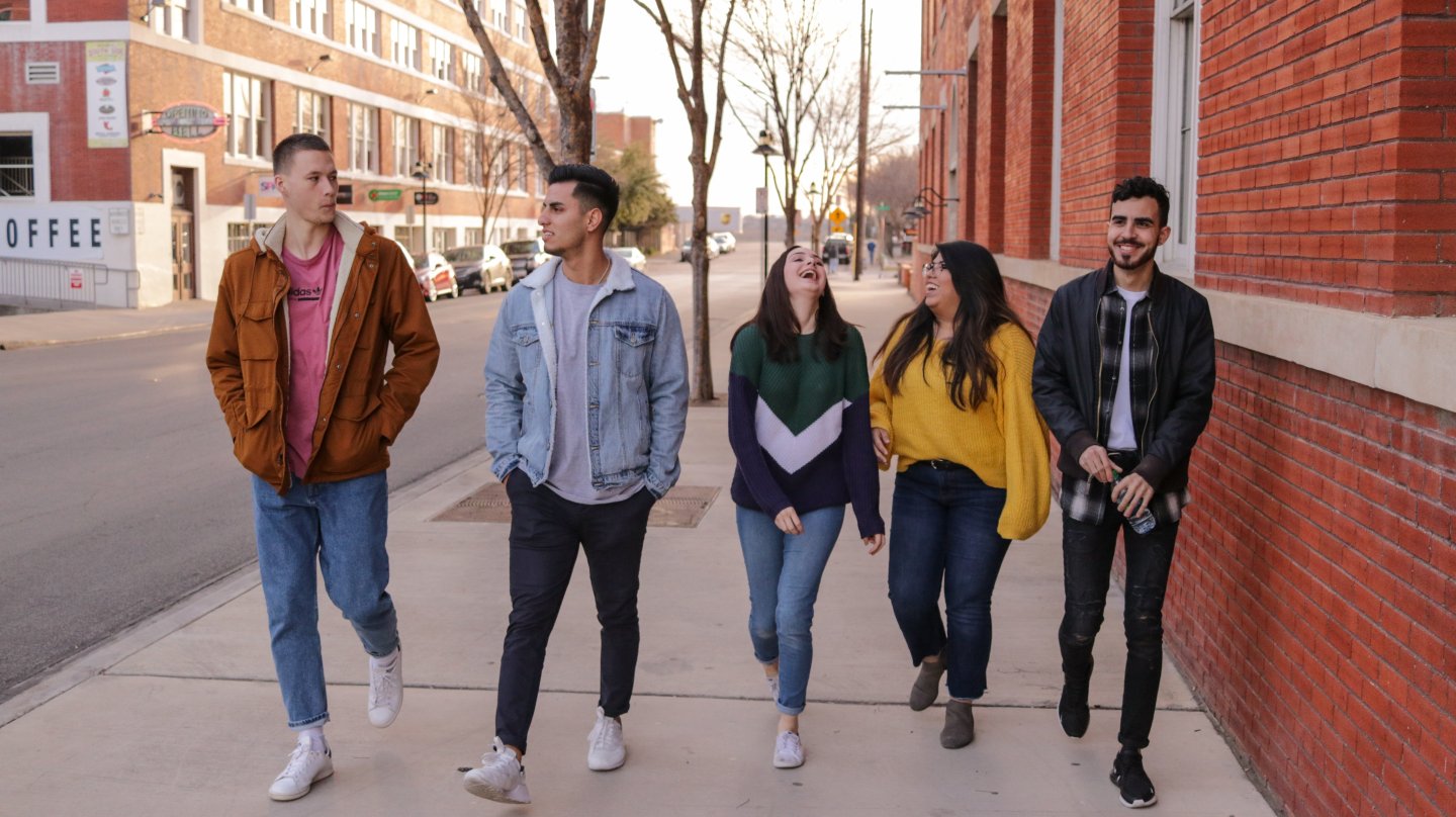 young adults walking down the street