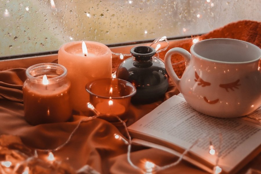 warm lights and candles on a window sill