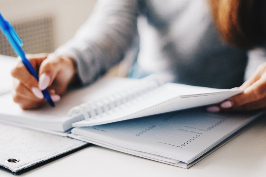 woman writing in a planner