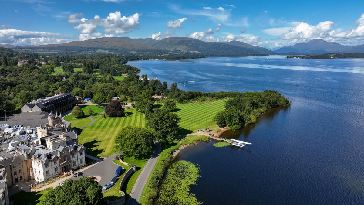 drone view of cameron house grounds and lake