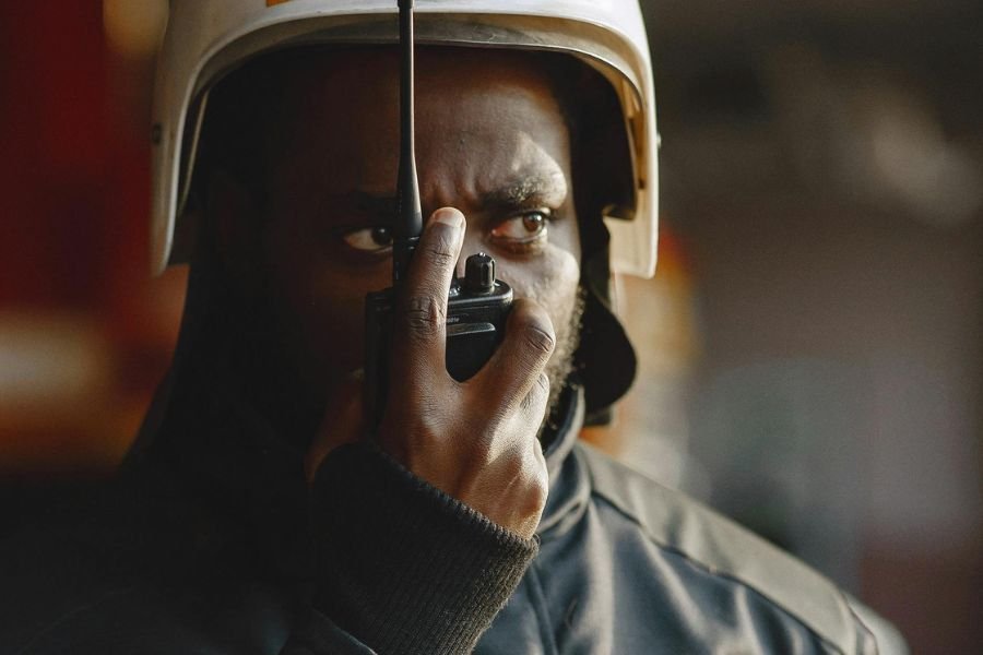 first responder talking into a handheld radio