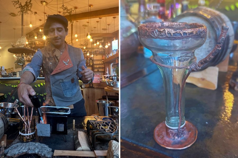 bartender creating cocktail, glass made of reused bottle and copper