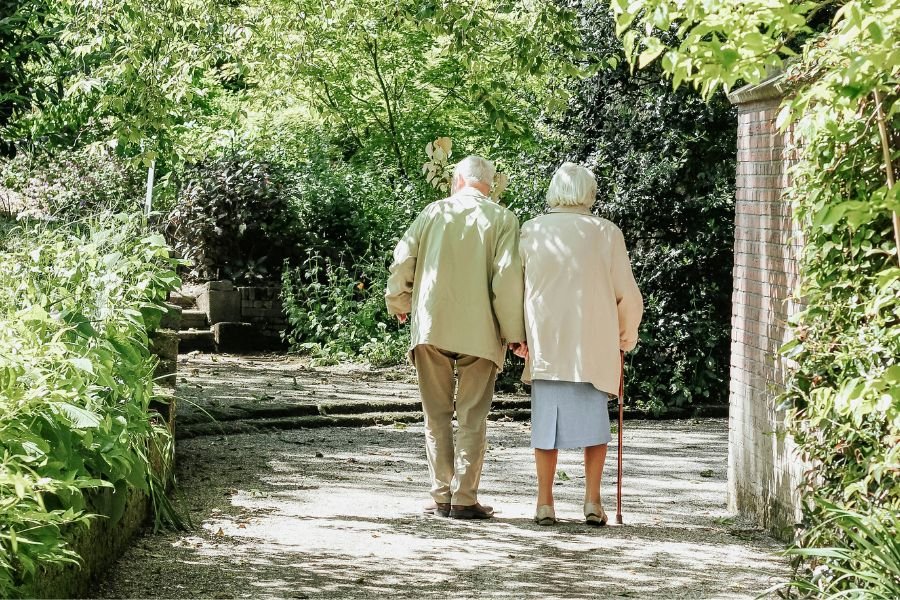 elderly couple walking hand in hand