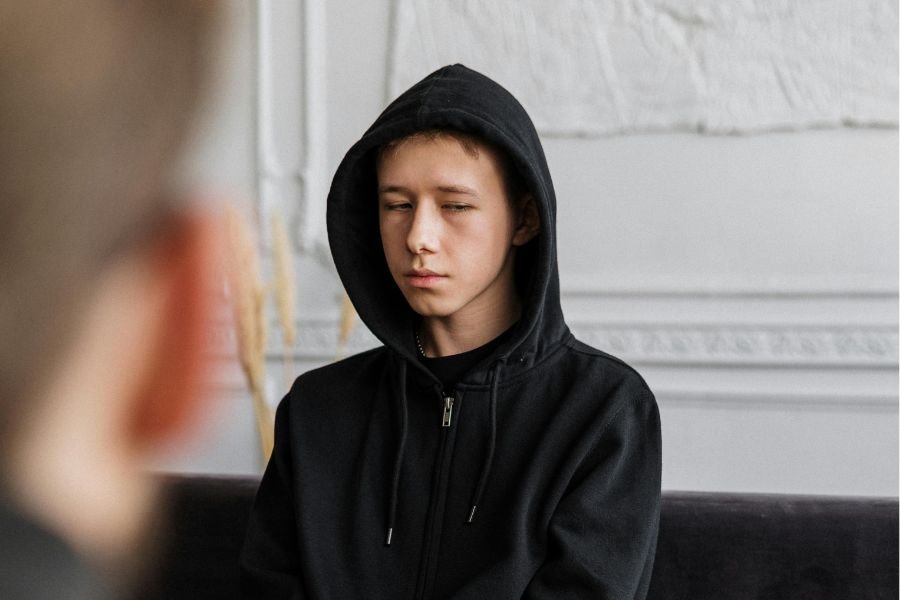 kid looking pensive in a therapist's office