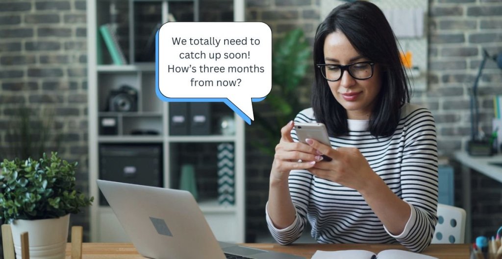 woman texting at a desk
