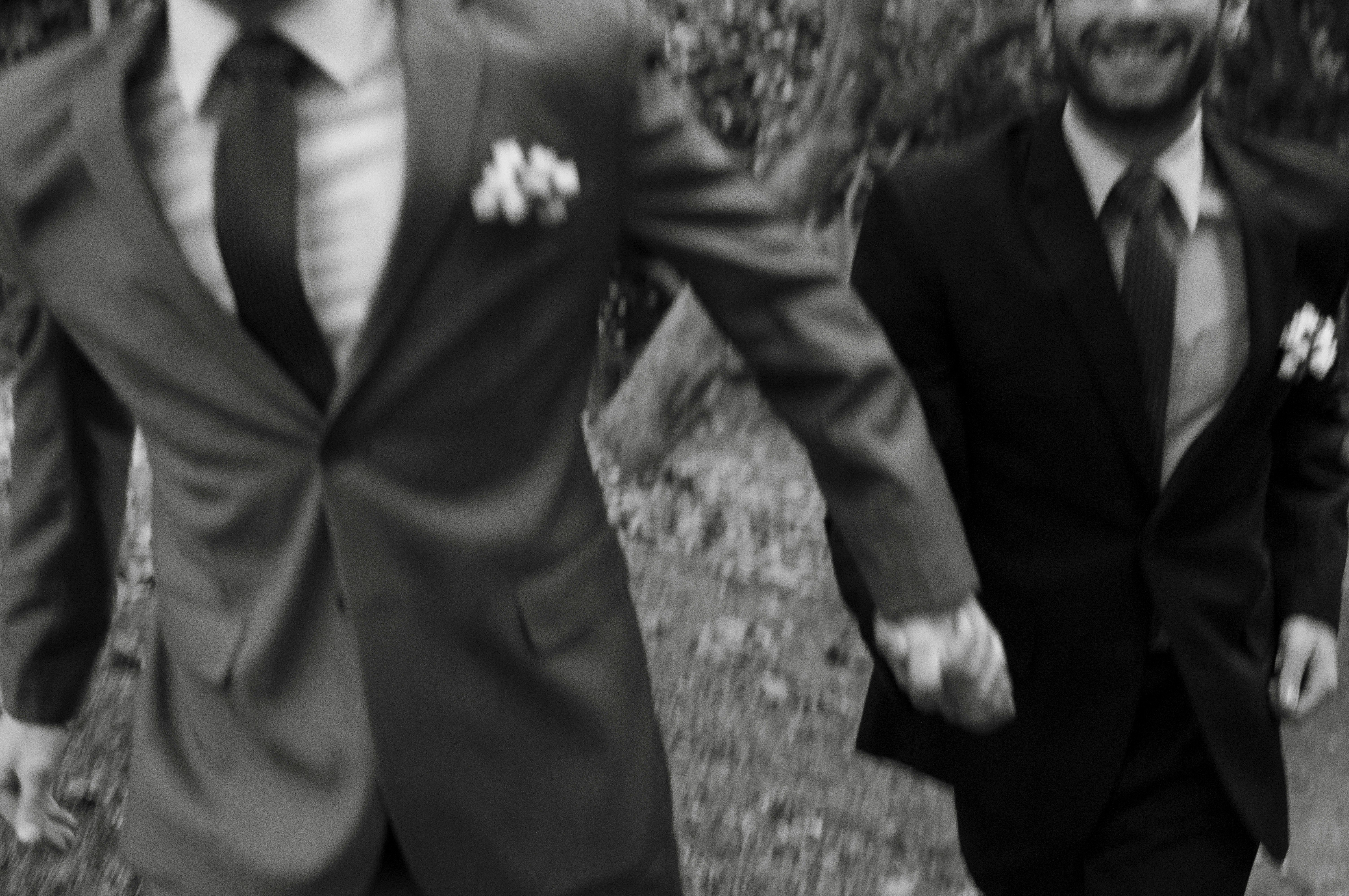 two grooms run happily at a wedding