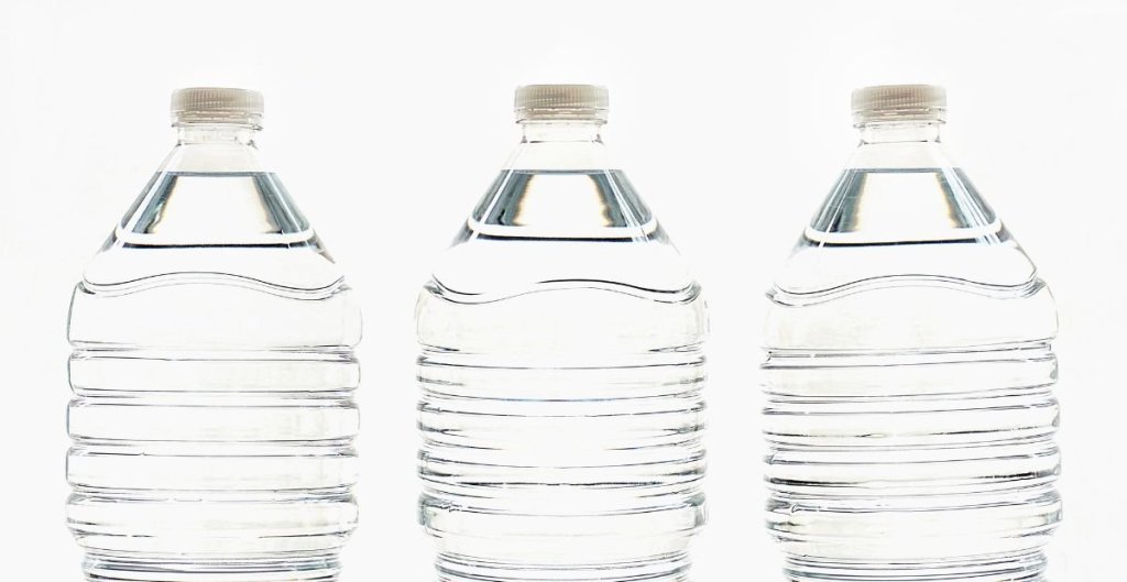 three disposable plastic water bottles