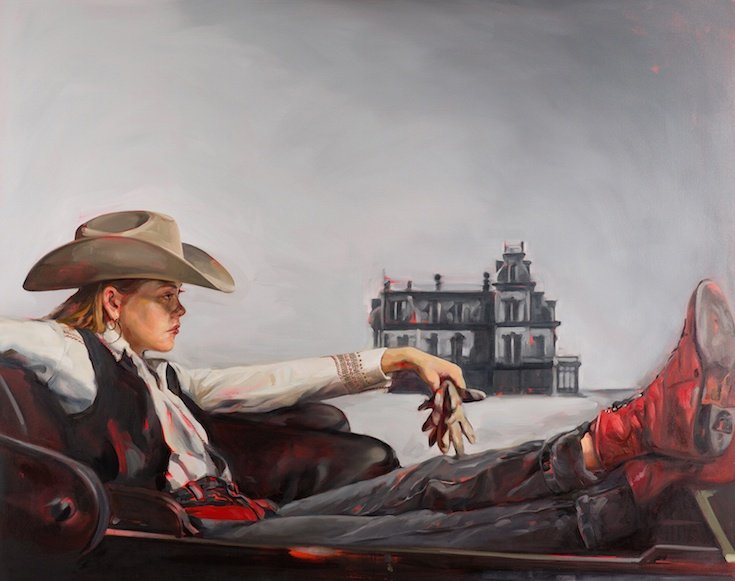 Woman lounging cowboy gear and red boots