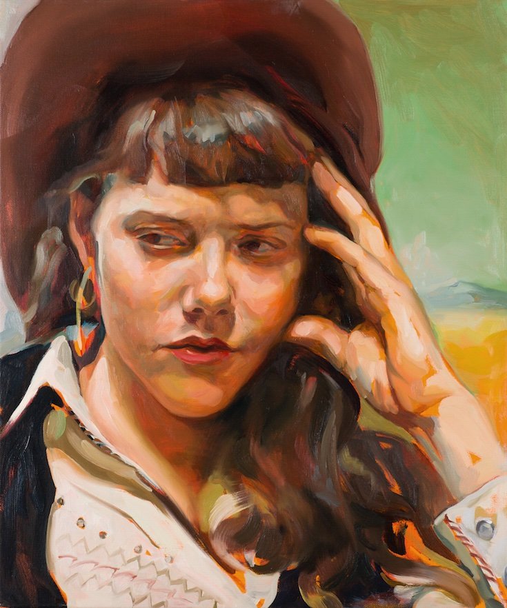 Woman in old fashioned Western scene in cowboy gear