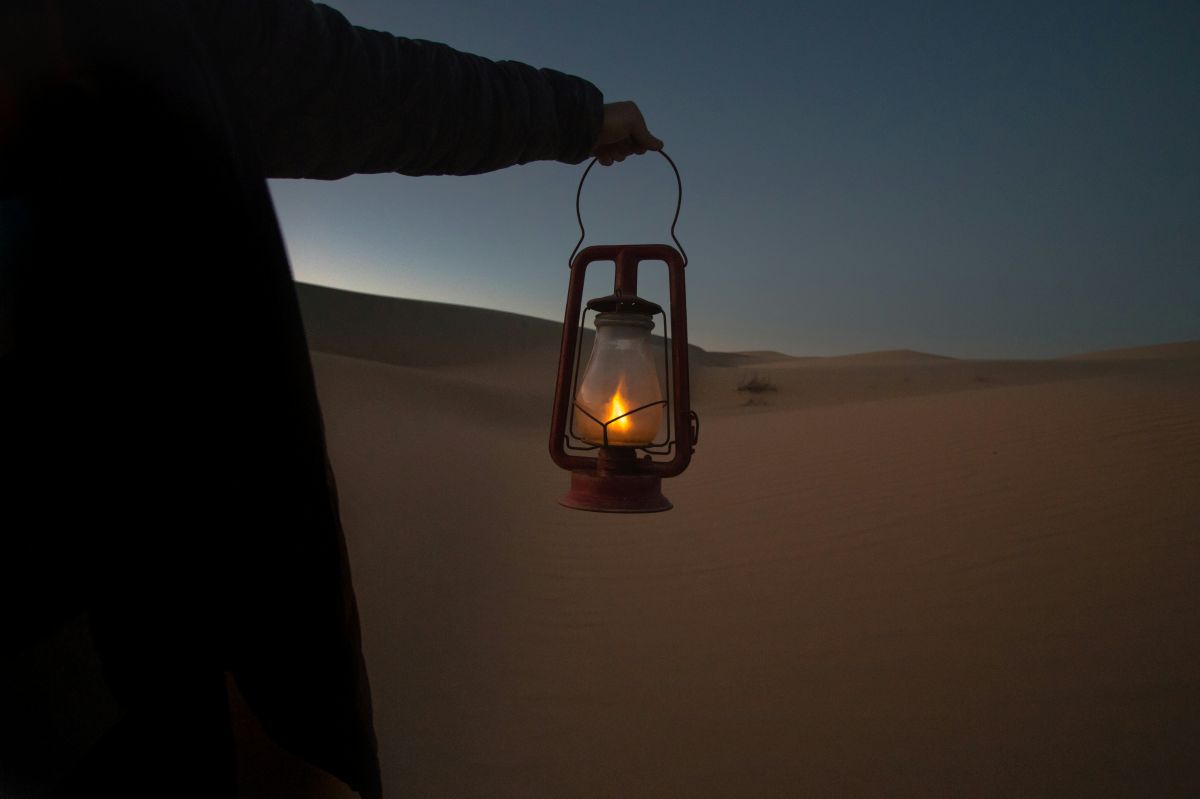 A figure holding a gas lantern