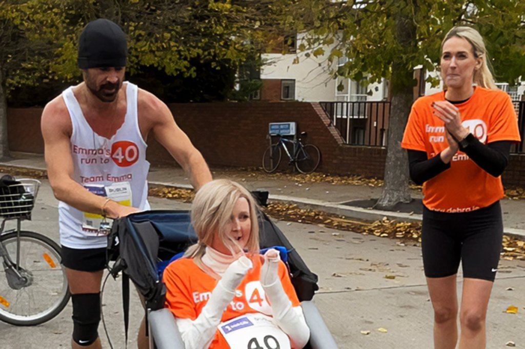 Colin Farrell pushes friend Emma Fogarty across the finish line of a marathon.