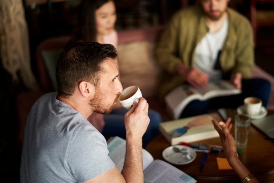 people in a coffee shop with books