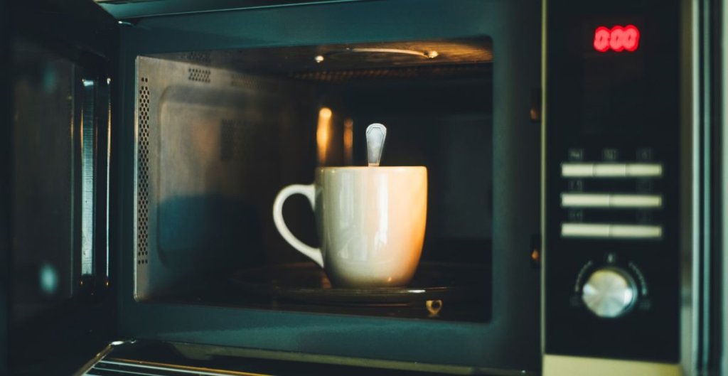 mug in microwave with a metal spoon in it