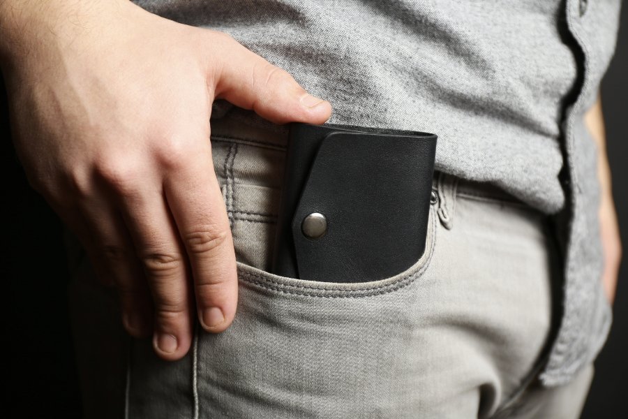 man putting wallet in front pocket
