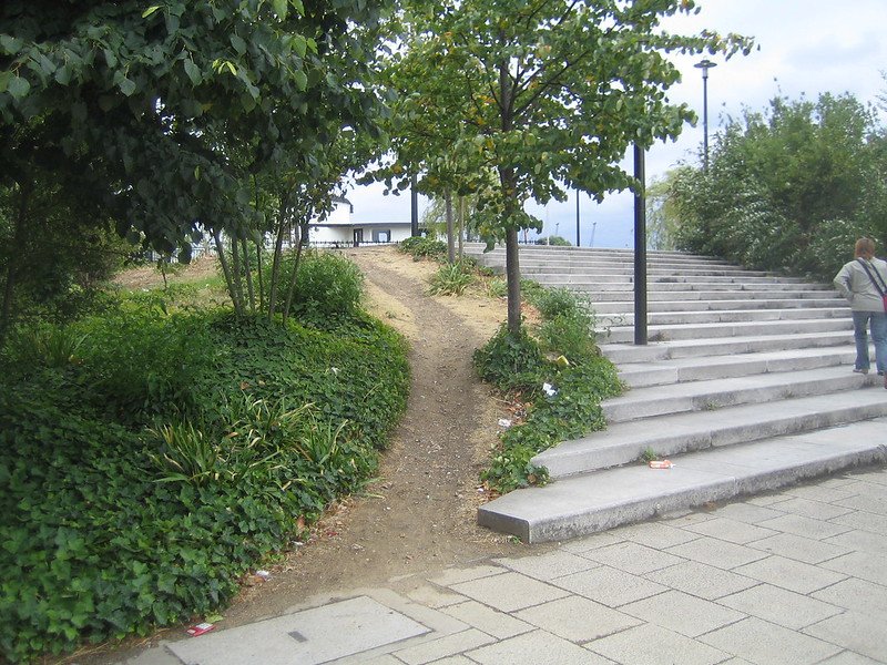 A path worn in the dirt next to stairs