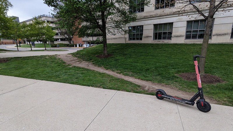 A dirt path next to sidewalk