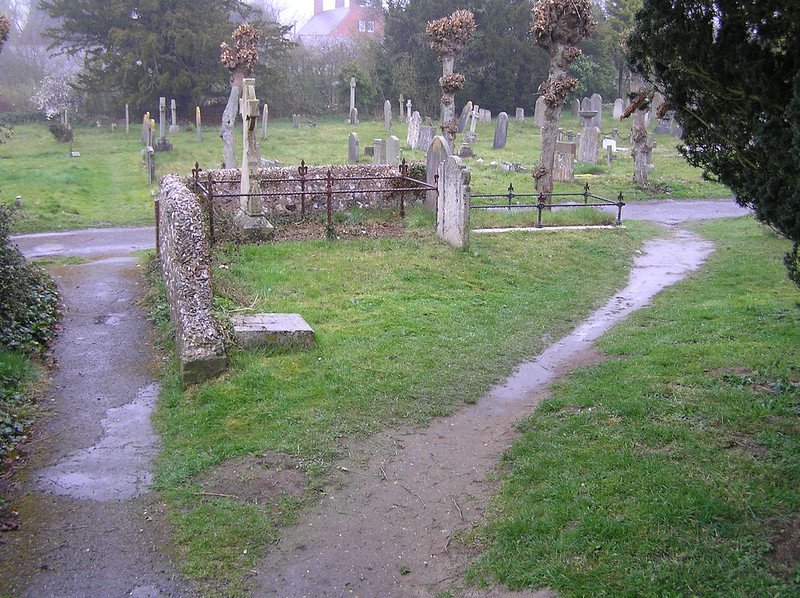 A dirt path cutting through graveyard