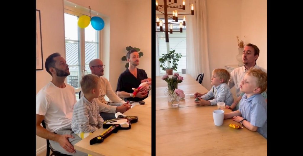 dads singing with kids around a dining table