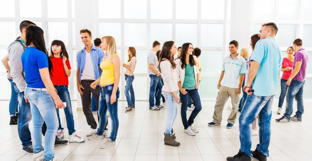 group of people socializing in a large room
