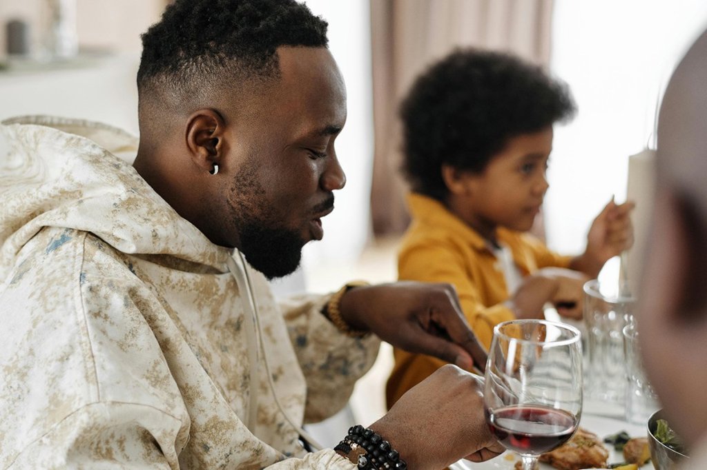 A man eats dinner with his family.