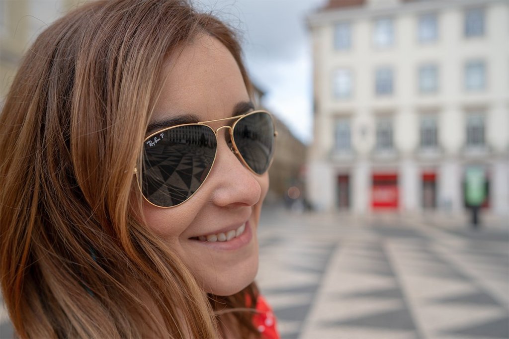 A woman wearing a pair of sunglasses.