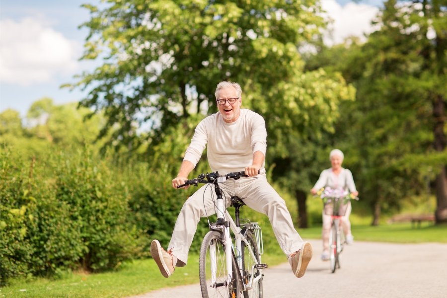 man joyfully riding a bicycle.