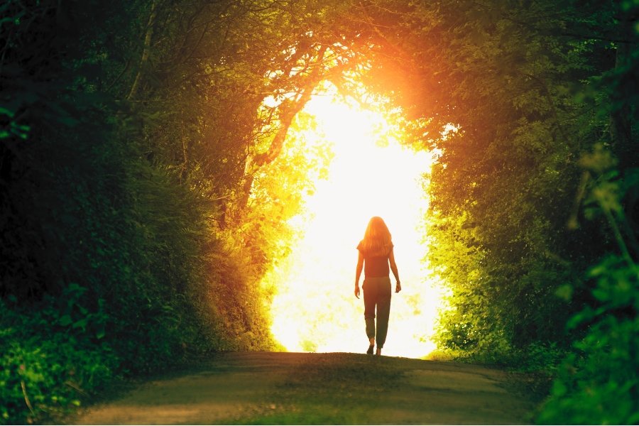 woman walking into the light