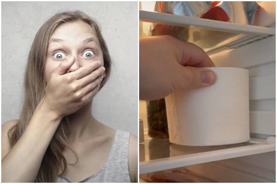 a woman covers her mouth in shock; a man places a roll of toilet paper in the refrigerator.