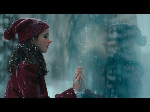 girl touching a glass wall in the snow