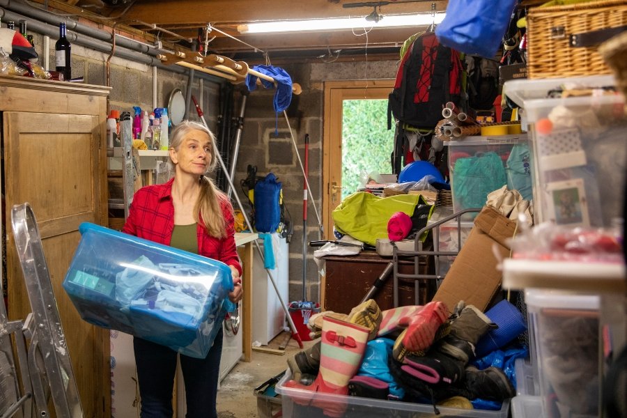 woman moving a bin in a storage space