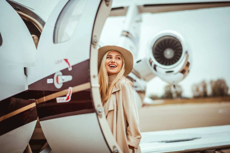 young woman getting onto a private jet