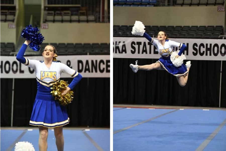 cheerleader in white and blue uniform cheering and leaping.
