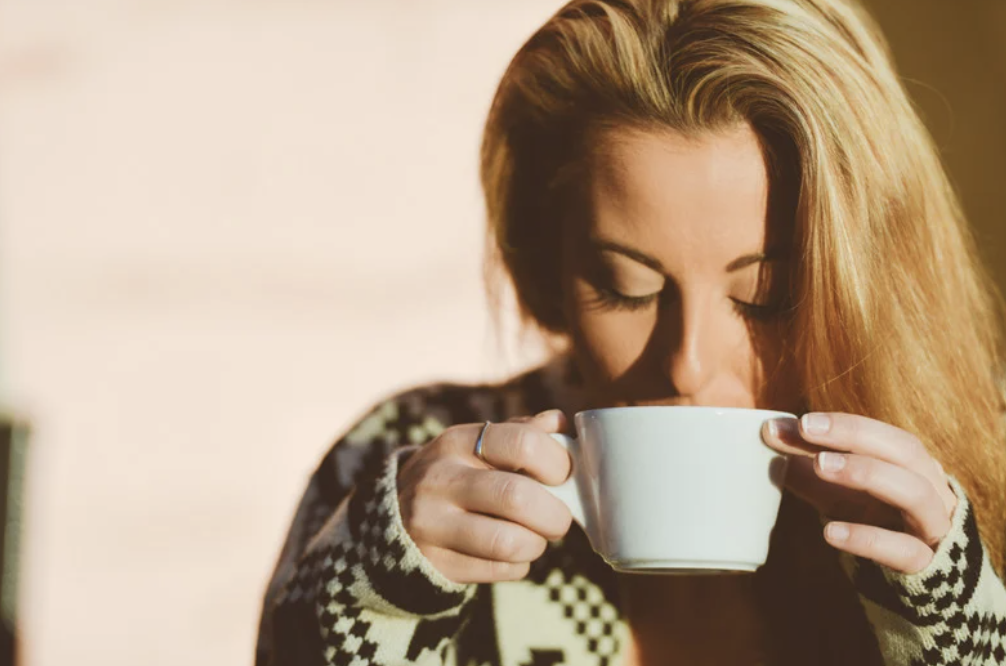 A woman sipping coffee alone.