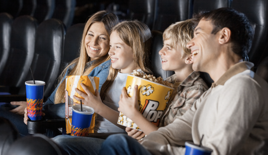 Family enjoying a movie at a movie theater