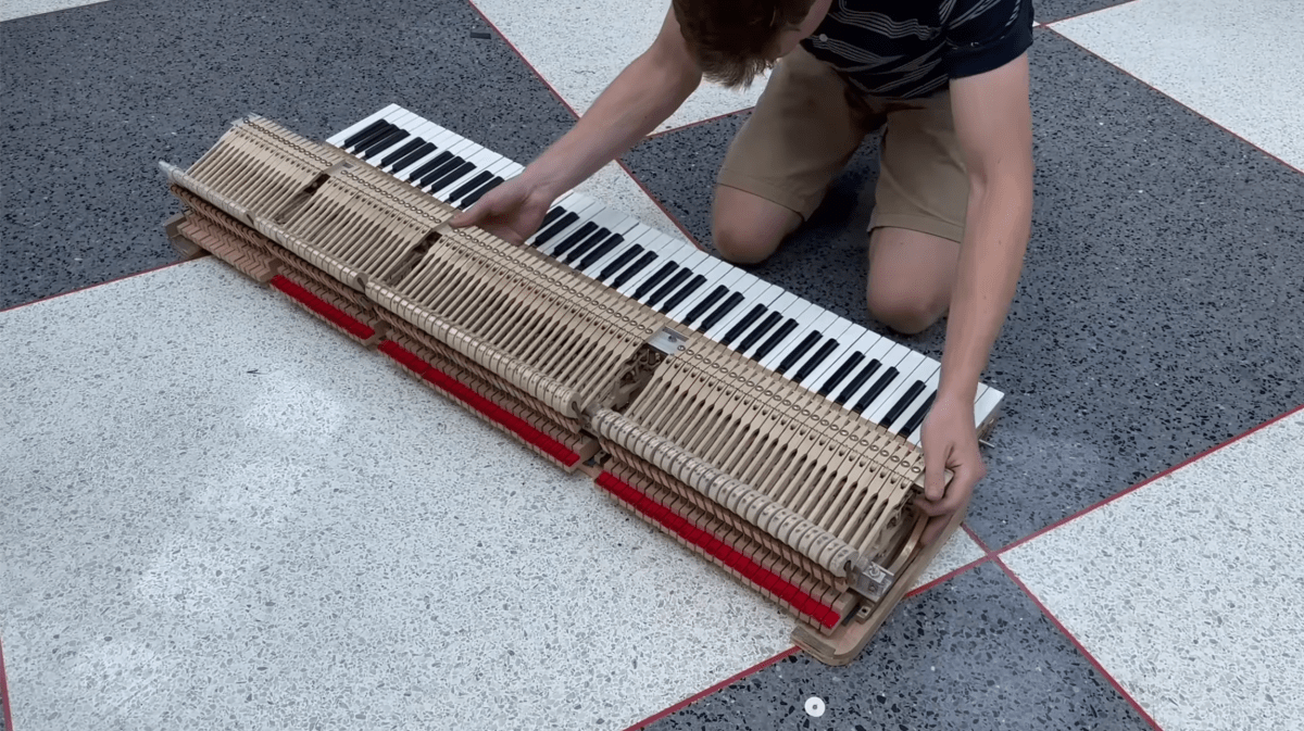 The Piano Doctor mid-surgery: Josiah Jackson takes the instrument apart.