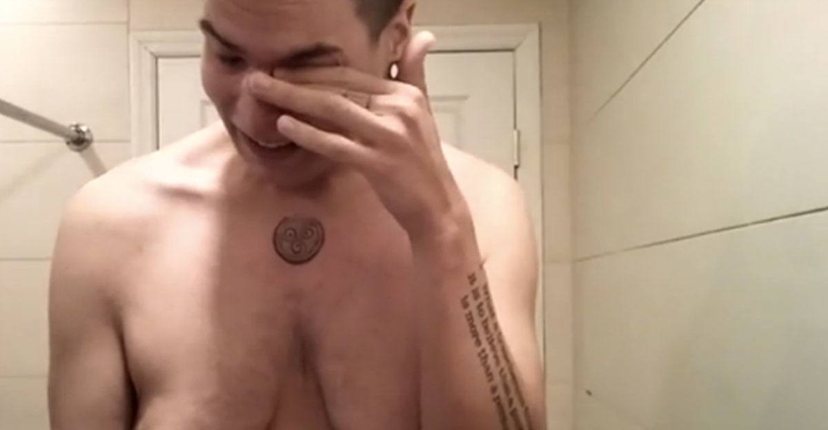 man cries in shower