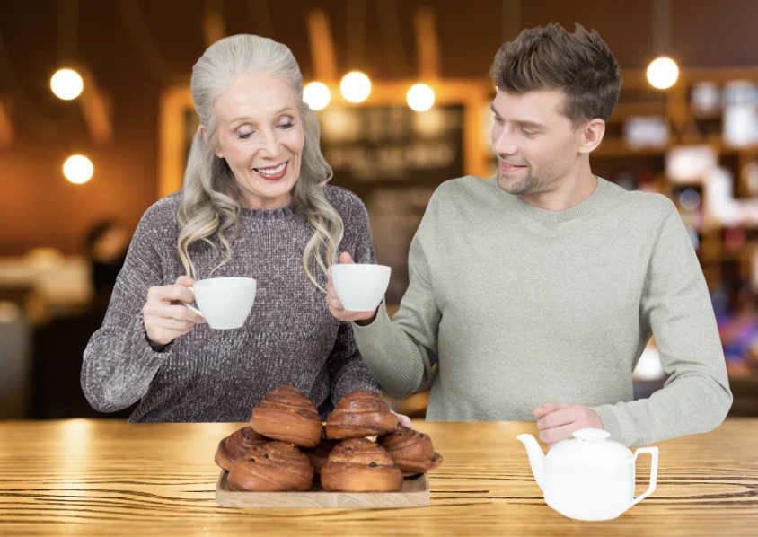 An older woman and younger man having coffee and pastries together in a cafe