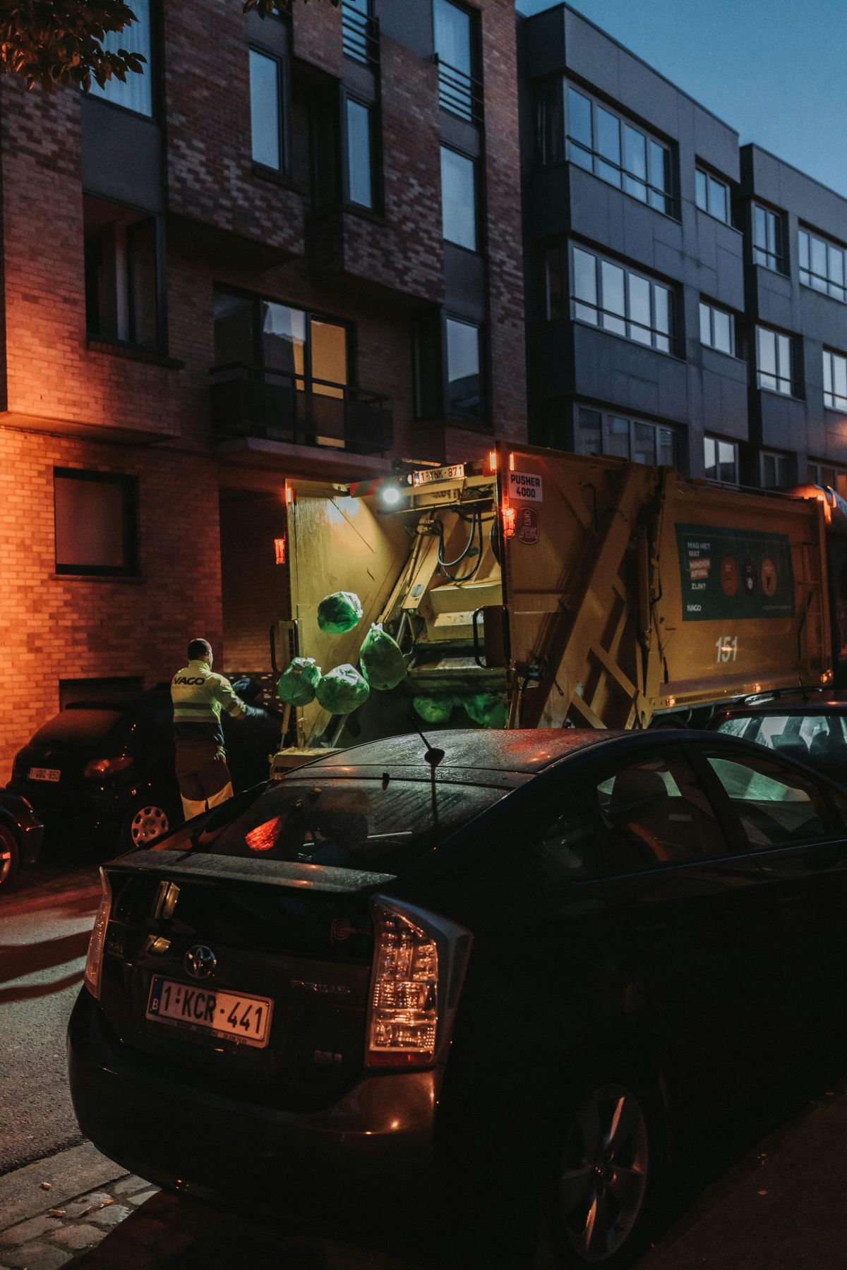 garbage truck picking up trash on the street