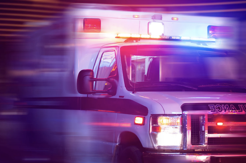 An image of an ambulance driving at a high speed